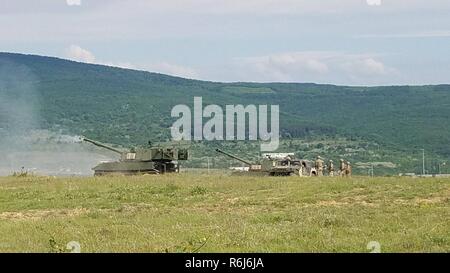 Campo gli equipaggi di artiglieria da una batteria, 3° Battaglione, 29 Campo reggimento di artiglieria, 3° Brigata corazzate contro la squadra, 4a divisione di fanteria, condotta gunnery qualificazione in dipinto recentemente M109A6 Paladin semoventi obici a Novo Selo Area Formazione, Bulgaria, 18 maggio 2017. Lo schema di colori su i paladini è stato cambiato da desert tan per adattarsi meglio l'ambiente come gli equipaggi di partecipare nel funzionamento Atlantic risolvere, fornendo una persistente presenza di scoraggiare le aggressioni in Europa orientale. Foto Stock