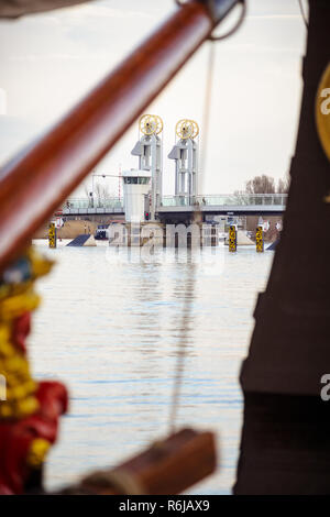 Guardare attraverso il ponte della città lungo vecchie barche a vela sul fiume IJssel quay della città olandese di Kampen Foto Stock