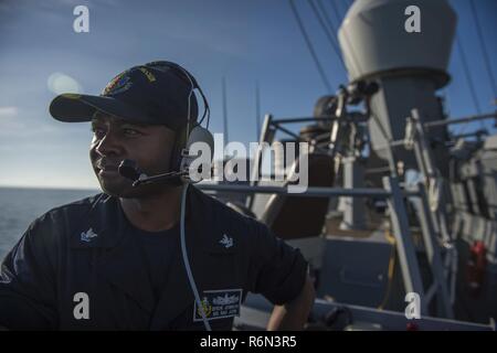 CAM RANH porto internazionale, Vietnam (maggio. 31, 2017) Quartermaster 2a classe Byron Johnson si erge guarda sul lato a tribordo lookout a bordo del Arleigh Burke-class guidato-missile destroyer USS McCain (DDG 56) come la nave tira in Cam Ranh porto internazionale. McCain è di pattuglia NEGLI STATI UNITI 7 flotta area di responsabilità a sostegno della sicurezza e della stabilità in Indo-Asia-regione del Pacifico. Foto Stock