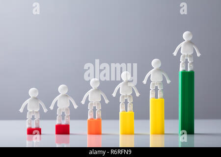 Le figure umane in piedi sulla parte superiore del grafico in aumento Foto Stock