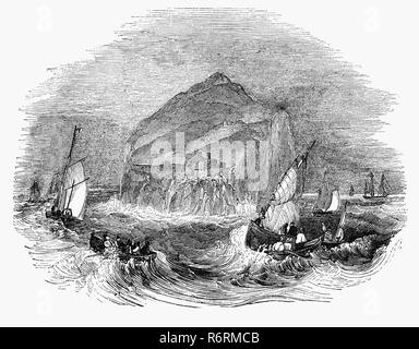 Barche a vela in mare in tempesta off il Bass Rock, o 'BAS', un'isola nella parte esterna del Firth of Forth a circa 2 chilometri di offshore nell est della Scozia. Dopo Cromwell dell' invasione nel 1671, il castello divenne una famigerata prigione per i religiosi e le religiose e i prigionieri politici; specialmente Covenanters scozzese movimento presbiteriano che derivano il loro nome dalla parola alleanza significato una banda, documento legale o accordo, con particolare riferimento al patto tra Dio e Israele nel vecchio Testement. La fortezza è stata abbandonata dal governo nel 1701. Foto Stock