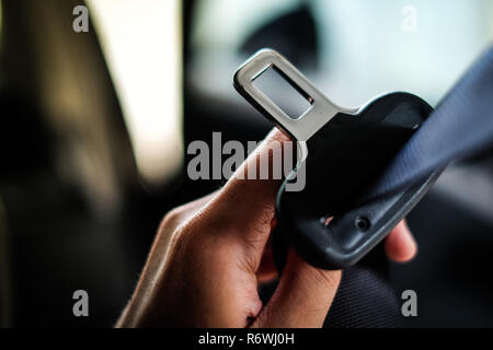 Mano del conducente titolare della cintura di sicurezza (cintura di sicurezza) bloccare in auto prima di guidare - Sicurezza & secure concetto. Foto Stock