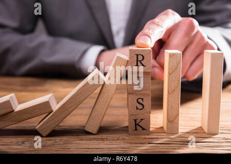 I mediatori un dito di arresto dei Dominos cada Foto Stock