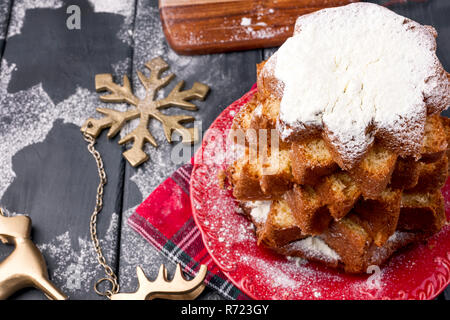 Italiano cupcake di Natale con zucchero a velo. Festa tradizionale cottura nella forma di un albero di Natale e il decor in legno scuro dello sfondo. Vista dall'alto. Spazio libero per copiare del testo. Foto Stock