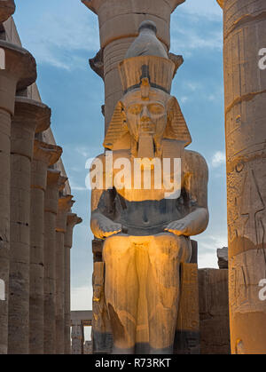 Grande statua di Ramses II accesa fino al crepuscolo in antichi egizi del Tempio di Luxor Foto Stock