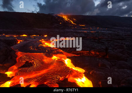 Colata di lava sul pendio del vulcano. Eruzione vulcanica e magma. Foto Stock