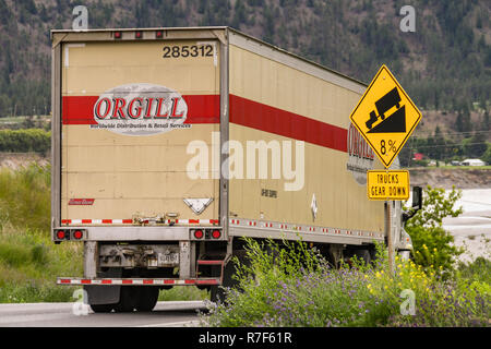 LILOOETT, British Columbia, Canada - Giugno 2018: Grande carrello merci passando un segno sul lato strada in Lilooett driver di avvertimento di una ripida collina. Foto Stock