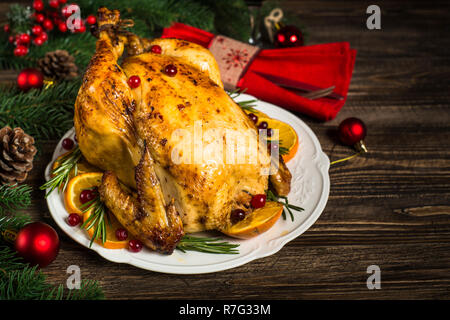 Chrismas il pollo al forno con mirtillo rosso, arancio e rosmarino. Cena di Natale. Foto Stock