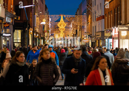 Domenica 09 dicembre 2018. La folla shopping sotto la Chrismas luci di Strada di Grafton St. Dublino. Foto Stock