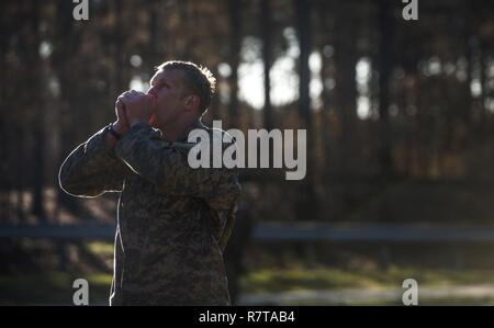 Un U.S. Army Ranger scalda le mani dopo un ostacolo durante la migliore concorrenza Ranger 2017 a Fort Benning, Ga., Aprile 7, 2017. La trentaquattresima edizione annuale di David E. Grange Junior Ranger migliore concorrenza 2017 è un evento di tre giorni consistente di sfide per testare concorrente del fisico, mentale e capacità tecniche. Foto Stock