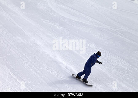 Snowboarder discesa sulla neve toelettatura pista da sci in inverno freddo giorno Foto Stock