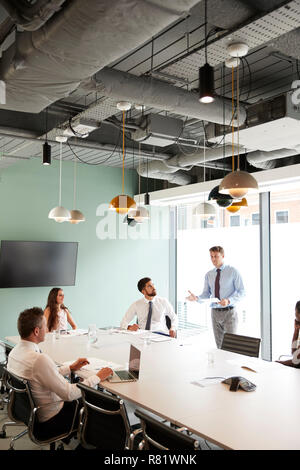 Imprenditore dando presentazione nella sala consiliare di Colleghi in Sala Riunioni Foto Stock