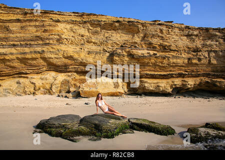 Giovane donna in bikini udienza presso La Mina spiaggia in Paracas riserva nazionale, Perù. Scopo principale della Riserva è di proteggere ecosistema marino e histo Foto Stock