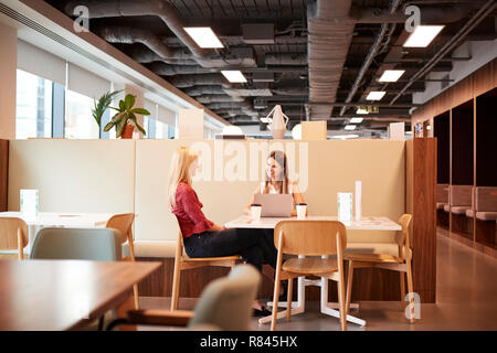 Due giovani imprenditrici avente intervista informale nella zona caffetteria all assunzione di laureati giorno di valutazione Foto Stock