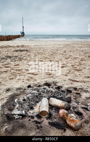 Bruciò lattine su una spiaggia, inquinamento ambientale concetto. Foto Stock