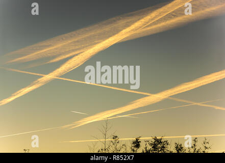 Aeromobile sentieri di vapore (contrails) che forma dopo il passaggio di un alto piano di volo.queste sono state prese a sunrise dal mio giardino nel sud-ovest della Francia. Foto Stock