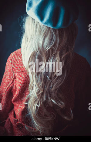 Donna storico in cappotto invernale in possesso di un libro Foto Stock