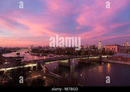 Di sera, al crepuscolo e di notte vista, rosso tramonto sul fiume Moskva e cielo rosso, il nuovo monastero del Salvatore e Ponte Novospasskiy a Mosca, in Russia. Foto Stock