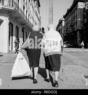 Due vecchie signore camminando nel sole , Bologna, Italia . realizzato da rolleiflex Foto Stock