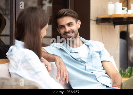 Sorridenti uomo avente una buona conversazione con giovane donna Foto Stock