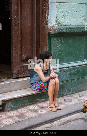 Vecchia donna cubana si siede sui gradini in Havana Cuba Foto Stock