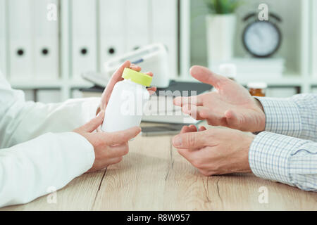 Il paziente e il medico considerando supplemento nutrizionale la terapia in ufficio medico Foto Stock