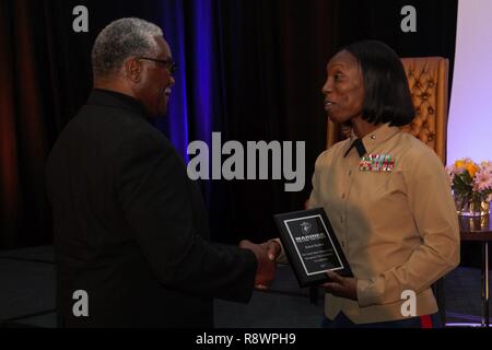 Il tenente colonnello Melanie Bell-Carter presenta l'eccellenza nella Leadership Award a Robert Porcher, il padre, che ha accettato il premio a nome suo, durante la MEAC Hall of Fame per il pranzo del 9 marzo 2017. Porcher era una sporgenza estremità difensiva per il South Carolina State University Bulldogs prima che ha fatto la storia come il primo bulldog a essere redatto nel primo round della cambiale di NFL. Porcher è anche una comunità di leader, egli dispone attualmente di una fondazione per la ricerca sul cancro e sollievo che genera migliaia di dollari all'Università del Michigan. Il partenariato MEAC fornisce la marina degli Stati Uniti Cor Foto Stock