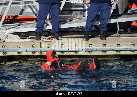 Coast Guard i membri dell'equipaggio dalla Coast Guard settore nord del New England dimostrano l'uso di acqua fredda tuta di immersione per le notizie locali media al Casco Bay, Venerdì, 7 dicembre 2018. La Guardia Costiera ha ospitato l'evento per evidenziare l'importanza commerciale di sicurezza per i pescherecci e le recenti Novembre 14 Il salvataggio di tutti i quattro membri di equipaggio a bordo del peschereccio Aaron & Melissa II, circa 60 miglia al largo della costa di Rockland, Maine. Foto Stock