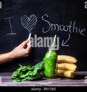 Fresco verde smoothie con banane e spinaci con titolo Amo smoothie sulla lavagna Foto Stock