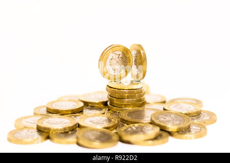 Pile e cumuli di British GBP monete doro Moneta soldi su sfondo bianco con spazio vuoto Foto Stock