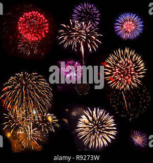 Insieme colorful di otto fuochi d'artificio esplosa, isolato su sfondo nero. Luminose fiori di fuoco di festosi fuochi d'artificio vari colori e forme di notte s Foto Stock