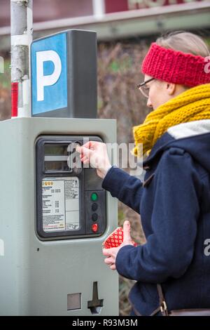 La donna acquista un biglietto di parcheggio da un parcheggio ticket distributore, all interno della città. Parcheggio pubblico, Essen Foto Stock