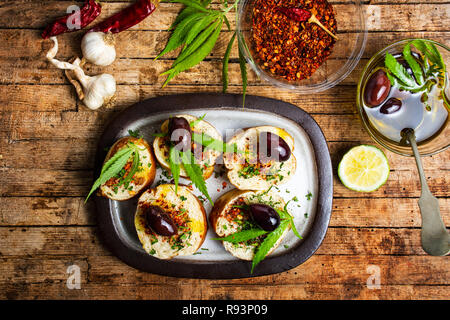 In casa la bruschetta con la marijuana e ingredienti naturali in vista superiore Foto Stock