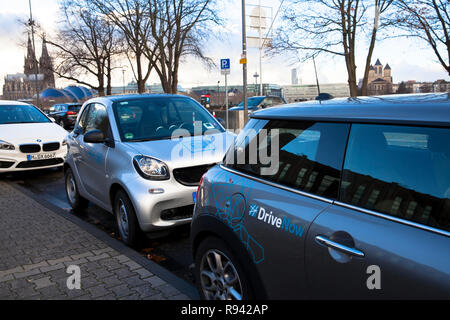 Vetture del carsharing aziende unità ora e Auto2Go nel quartiere Deutz di Colonia, Germania. Fahrzeuge der carsharing Unternehmen unità ora und auto Foto Stock