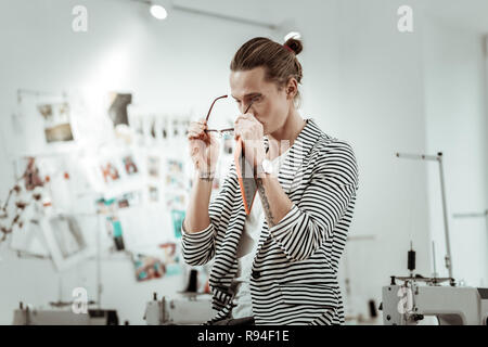 Bel giovane designer di moda con un tatuaggio sensazione di stanchezza Foto Stock