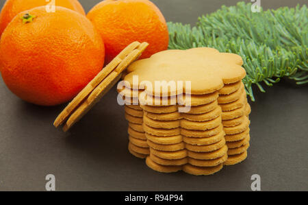 Mandarini - Natale frutta e biscotti allo zenzero su uno sfondo scuro. Foto Stock