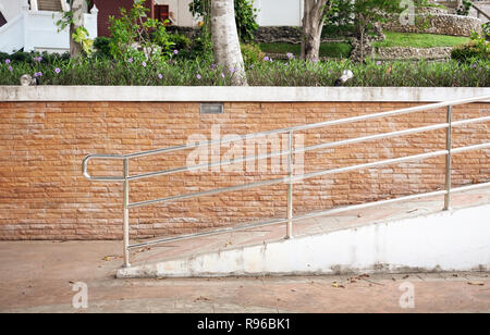 La parte di entrata di sfondo e il supporto di concetto di sedia a rotelle Foto Stock