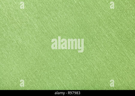Tessiturali di sfondo verde ondulata di carta ondulata, primo piano. Struttura di stropicciata crêpe light olive macro di cartone. Foto Stock