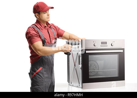 Tuttofare riparazione di forno con un trapano elettrico isolato su sfondo bianco Foto Stock
