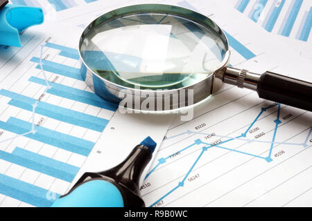 Lente di ingrandimento e i documenti finanziari. Audit e contabilità. Foto Stock