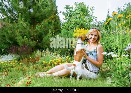 Donna che gioca con un cane Jack Russell Terrier Foto Stock