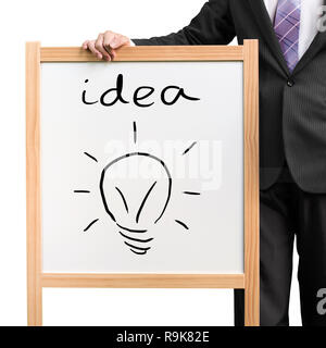 Imprenditore tenere in legno scheda bianca con la parola idea e illuminazione di disegno blub in sfondo bianco Foto Stock