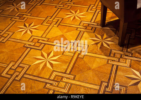 Ornamento vintage. Motivo decorativo pavimento in parquet con parte della sedia emty nell'angolo Foto Stock