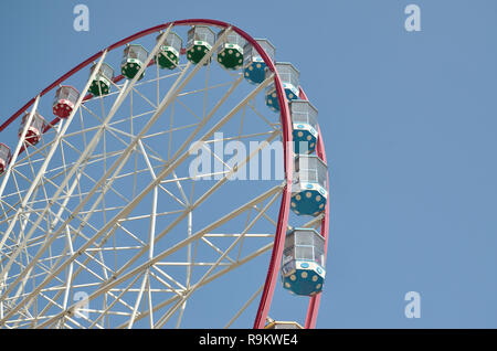 Grande e moderno multicolor ruota panoramica sul pulito cielo blu sullo sfondo Foto Stock