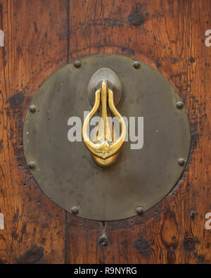 VALENCIA, SPAGNA - 24 MAGGIO 2018: Battito porta in ottone ornato su vecchia porta in legno Foto Stock