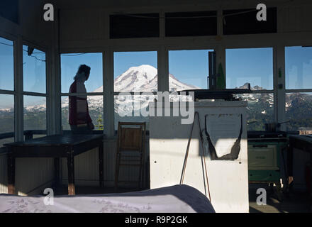 WA15613-00...WASHINGTON - escursionista sul balcone del picco Shriner avvistamento incendi con il Monte Rainier riempimento del western horizen. Foto Stock