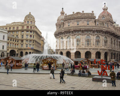 Genova Italia Dicembre 23, 2017: turisti di visitare Piazza de Ferrari (piazza principale) ad ammirare la famosa fontana e edifici storici Foto Stock