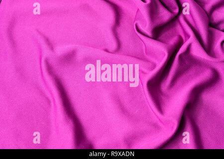 Tessuto rosa textured background. Sport Abbigliamento rosa jersey tessuto a trama. Foto Stock