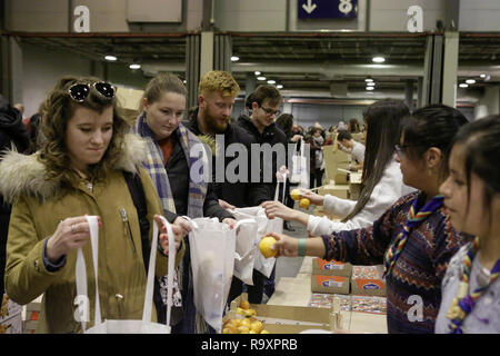 Madrid, Spagna. 28 dicembre, 2018. I giovani pellegrini ricevono la loro cena da volontari. Circa 15.000 pellegrini provenienti da Europa e al di là di assemblati a Madrid in Spagna per l annuale incontro europeo dei giovani della comunità di Taizé themed 'un pellegrinaggio di fiducia sulla terra ". La comunità di Taizé è un cristiano interconfessionale ordine monastico dalla Francia. Credito: Michael Debets/Pacific Press/Alamy Live News Foto Stock