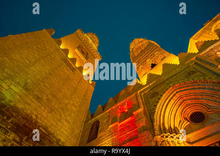 La bellissima pietra intagliata minareti di Qalawun complesso nella luminosa illuminazione serale al Cairo, Egitto Foto Stock